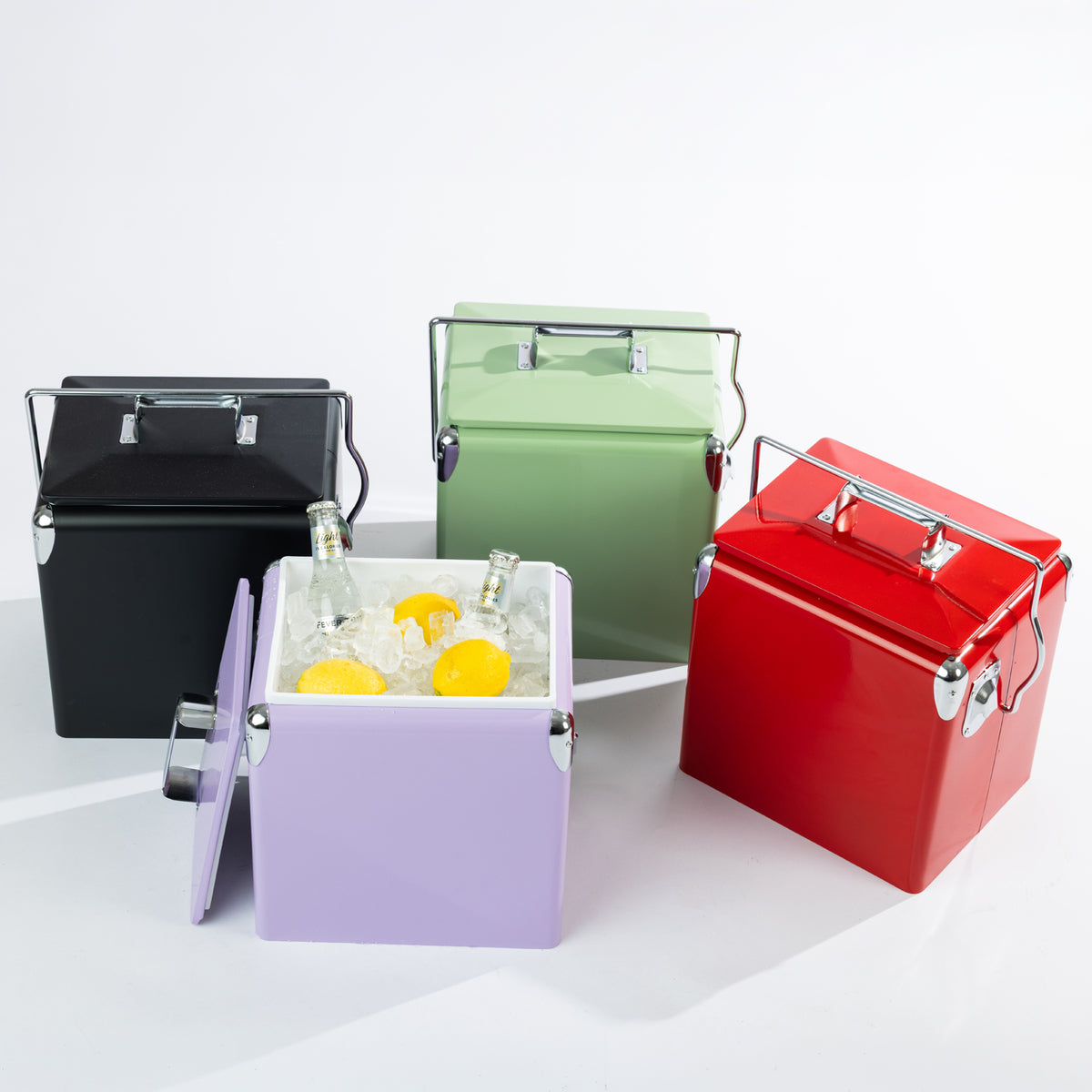 Four colourful Arctic cooler boxes displayed together, showcasing their removable lids, convenient carry handles and spacious insulated interiors. The Lilac cooler is filled with ice, drinks and fresh lemons.