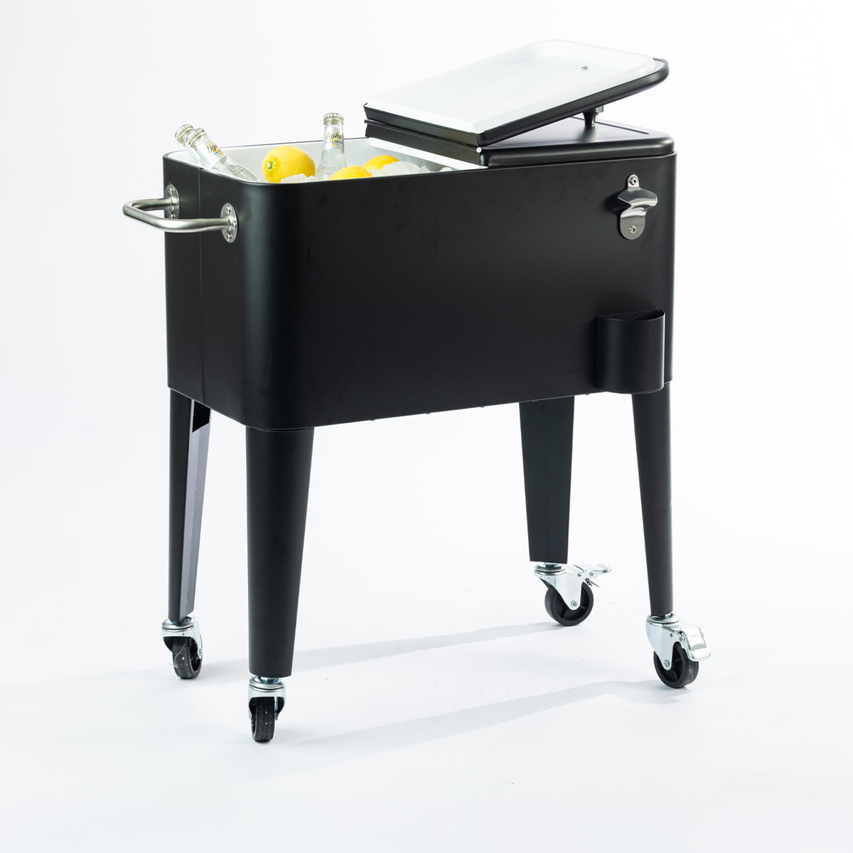Black 57L cooler box displayed with one lid open, revealing its white insulated interior filled with ice, bottled drinks and fresh lemons. Features a convenient split-lid design, side carry handle and caster wheels.