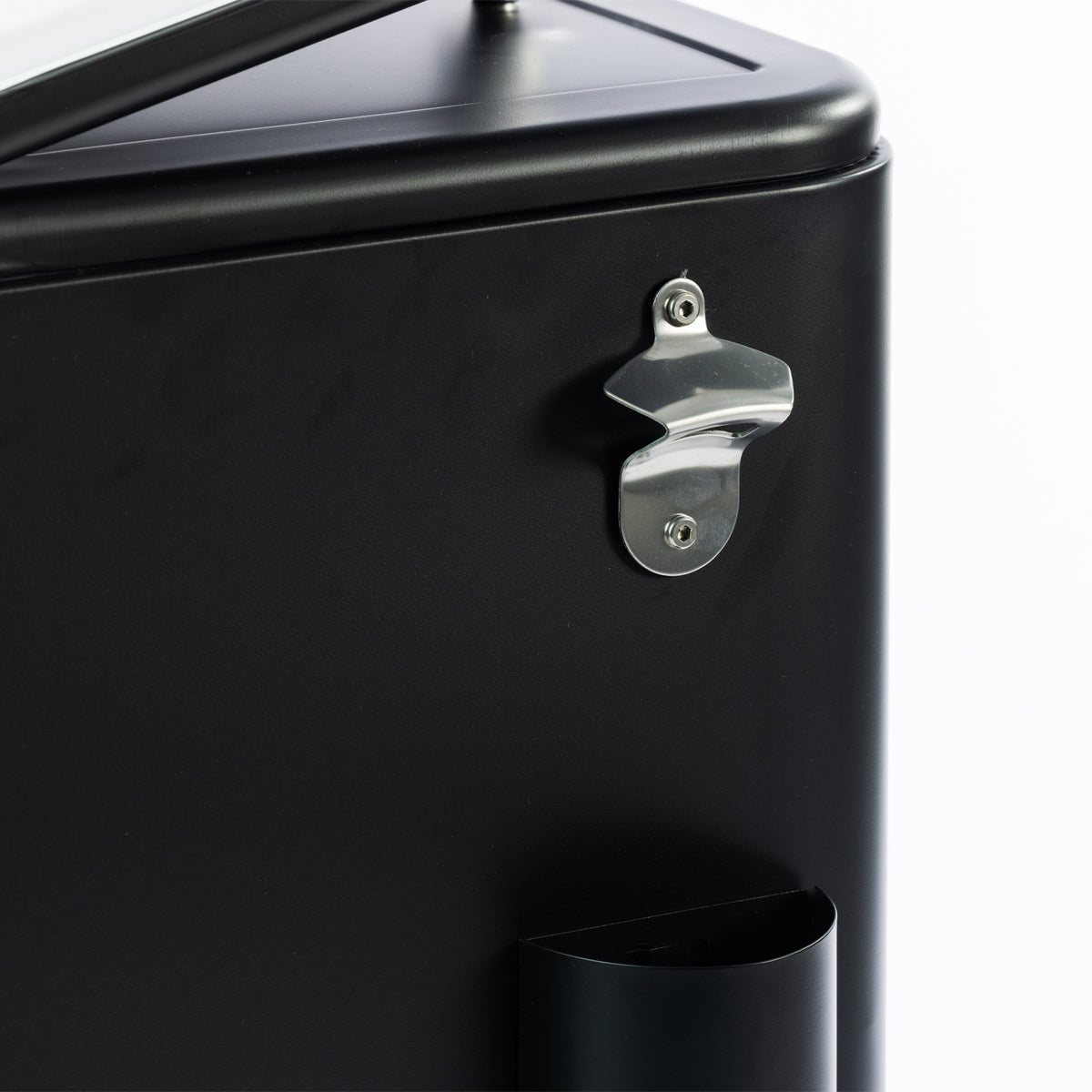 Detailed close-up of the silver metal bottle opener mounted on the side of the matte black cooler box, with the built-in bottle cap catcher positioned below.
