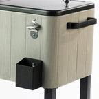 Detailed view of the cooler box's grey timber-effect finish, black side carry handle, silver built-in bottle opener and black bottle cap catcher mounted underneath.
