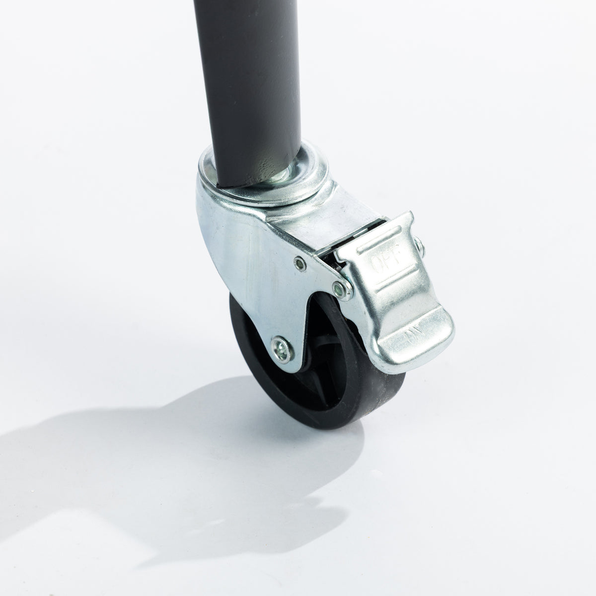 Close-up of a black caster wheel featuring a silver metal foot-operated brake with ON/OFF markings for easy locking and unlocking.