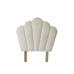 Front view of the bb&b Kids Shell Velvet Headboard in Ivory, featuring a scalloped shell design with plush velvet upholstery, vertical panel detailing and natural wooden legs.