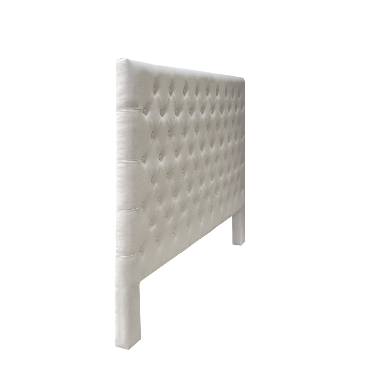 Side angle view of the Cream Jade Linen Look Headboard showcasing the elegant diamond tufted pattern, padded edges and upholstered legs.