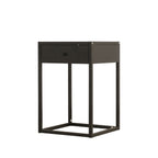 A modern black side table featuring a single drawer with a small round knob, supported by a minimalist open square metal frame, shown on a plain white background.