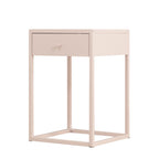 A minimalist single-drawer nightstand with a light blush pink finish and a square open metal frame base, shown on a solid white background.
