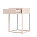 A minimalist side table with a single drawer in a pale blush pink finish, shown with the drawer pulled open to reveal the metal pull handle and track system. The table features a square open frame base.