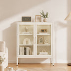 White glass-front shelving cabinet styled in a modern living room with books, decorative ornaments, framed artwork and a vase displayed across its shelves.