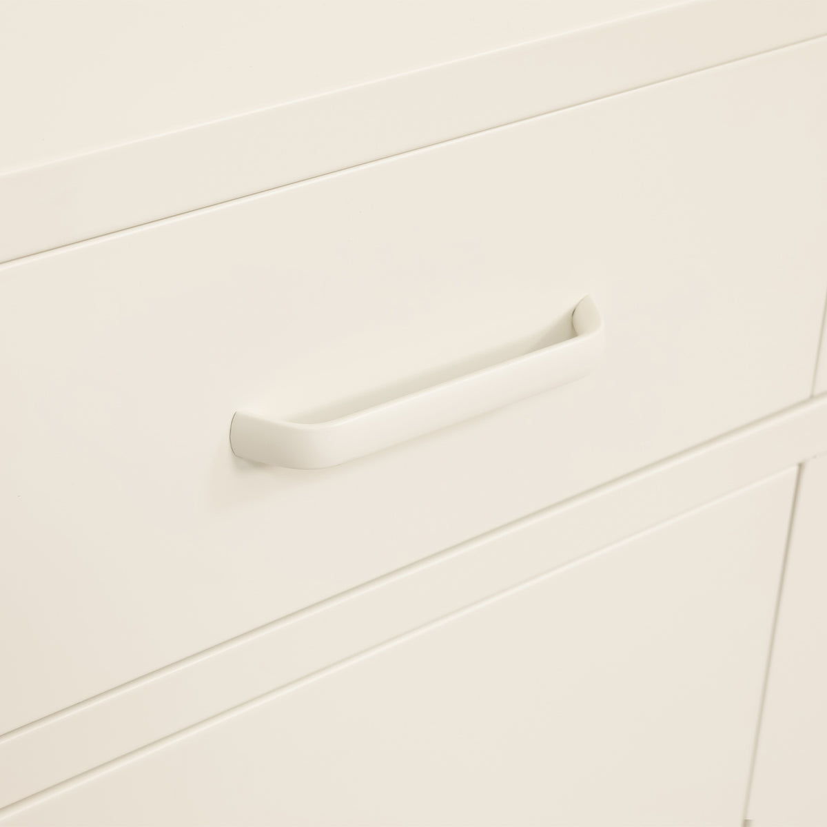 Close-up of the white sideboard's open drawer, showing the metal drawer runners and sliding mechanism.