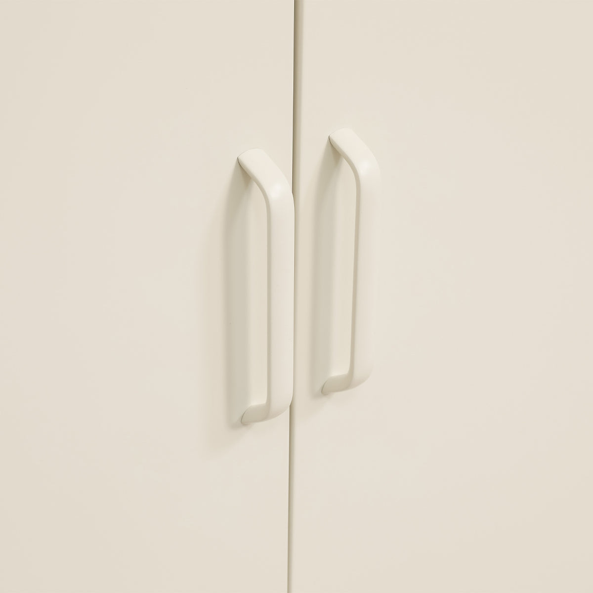 Close-up of the white sideboard's internal door frame, showing the magnetic door catch and fastening details.
