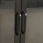Close-up of the black TV cabinet's glass-panelled doors, highlighting the matching black vertical handles and smooth frame.