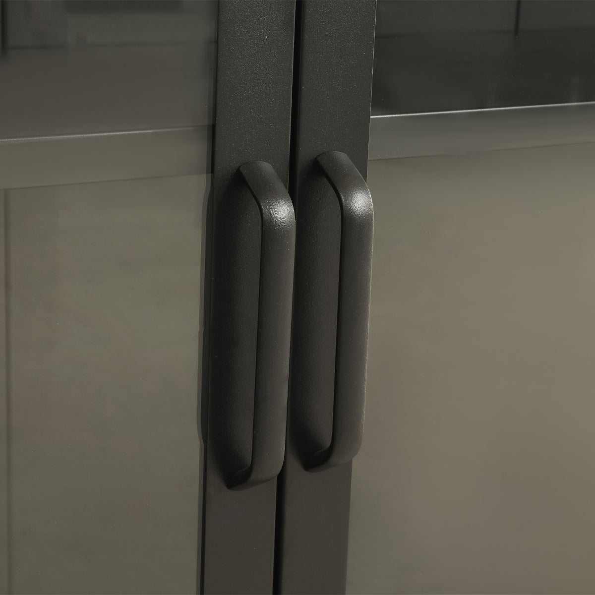 Close-up of the black TV cabinet's glass-panelled doors, highlighting the matching black vertical handles and smooth frame.