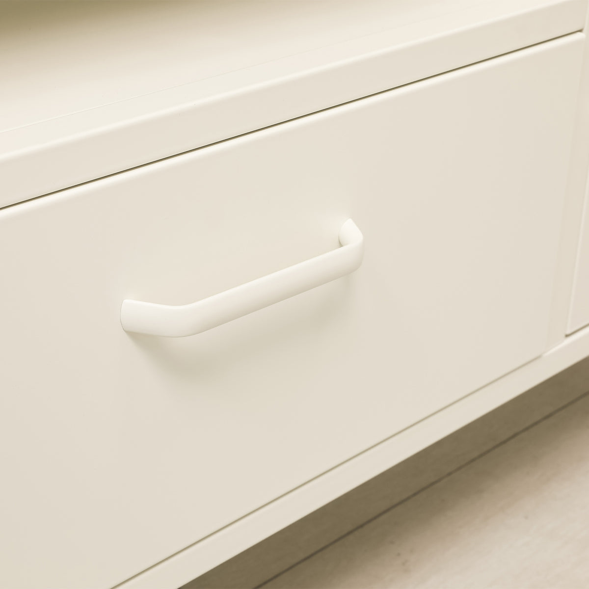 White TV cabinet with the right glass door open, revealing internal storage shelves and adjustable shelf supports.