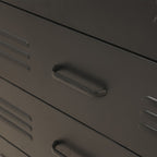 Close-up of a black metal drawer with a curved pull handle and ventilation slots on the side.