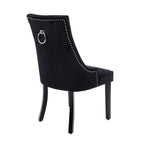 Rear view of the Design Republique Harvey Dining Chair in Black featuring smooth velvet upholstery, silver stud detailing, a chrome ring pull handle, and black timber legs.
