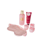 Rose & Berries body wash and hand cream displayed with a pink satin sleep mask and rose-shaped bath accessories on a white background.
