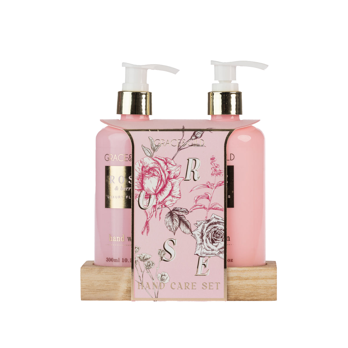 Grace & Gild Rose & Berries hand care set with two pink pump bottles presented on a wooden base with floral pink packaging.