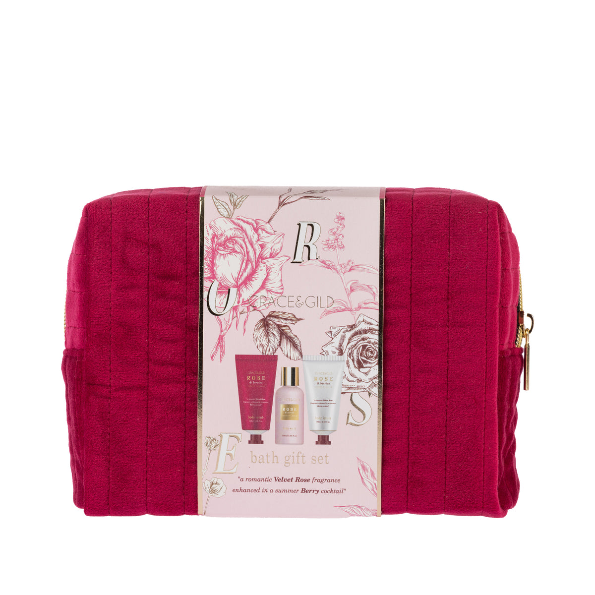 Grace & Gild Luxury Florals travel gift set presented in a rich berry-pink quilted cosmetic bag with gold zip detailing. A floral paper sleeve wraps around the bag and showcases the coordinating Rose & Berries body care products inside.