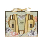 Royal Lily & Vanilla body wash, body scrub and body lotion in coordinated pale green and gold packaging against a white background.