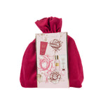 Grace & Gild Rose & Berries body care gift set presented in a plush berry-pink drawstring pouch. The floral sleeve features rose illustrations and images of the included products for a decorative gift-ready presentation.