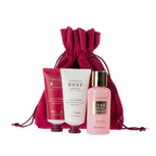 Rose & Berries hand cream, body lotion and body wash displayed in front of a matching berry-pink drawstring pouch, combining practical body care essentials with reusable gift packaging.