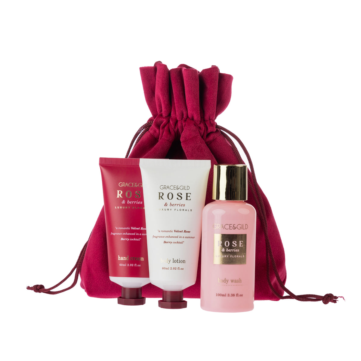 Rose & Berries hand cream, body lotion and body wash displayed in front of a matching berry-pink drawstring pouch, combining practical body care essentials with reusable gift packaging.