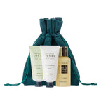 Royal Lily & Vanilla hand cream, body lotion and body wash displayed with the matching teal drawstring pouch, finished in soft green, cream and gold tones for an elegant coordinated look.