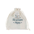 Grace & Gild Roman Spa Mini Travel Gift Set presented in a cream drawstring Roman Spa bag with hanging gift tag.