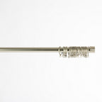 Curtain rod with decorative rings on a white background