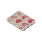 A square compact case with a beige background and watercolor-style pink hearts, shown closed on a plain white background.