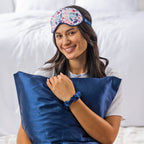 Grace & Gild Lottie Printed Satin Set in Navy, shown styled on a model with matching satin pillowcase, eye mask and scrunchie.