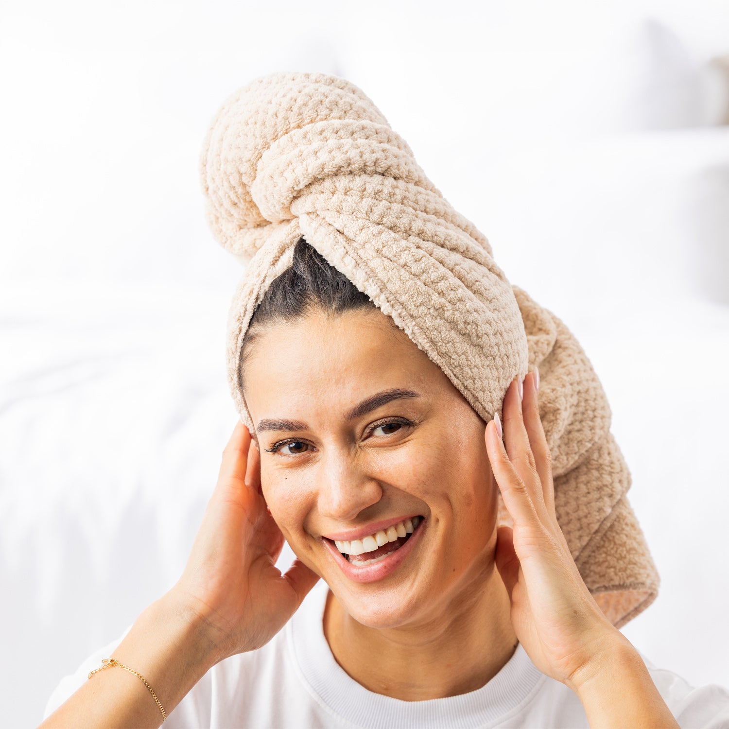 Grace & Gild Clementine Textured Hair Wrap in Natural, shown on a model from the front in a soft bedroom setting.