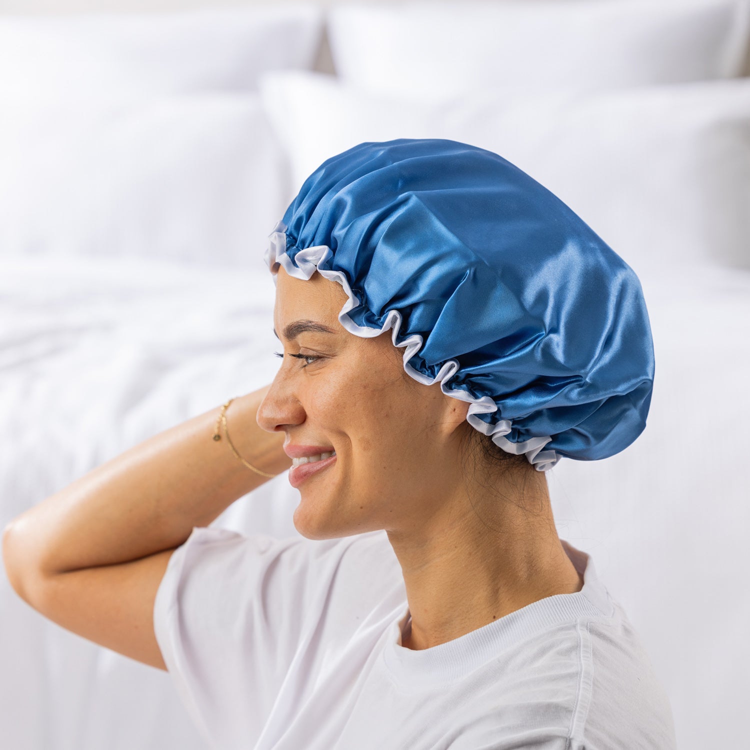 Grace & Gild Freya Pamper Set in Blue, showing a side view of the blue satin shower cap on a model.