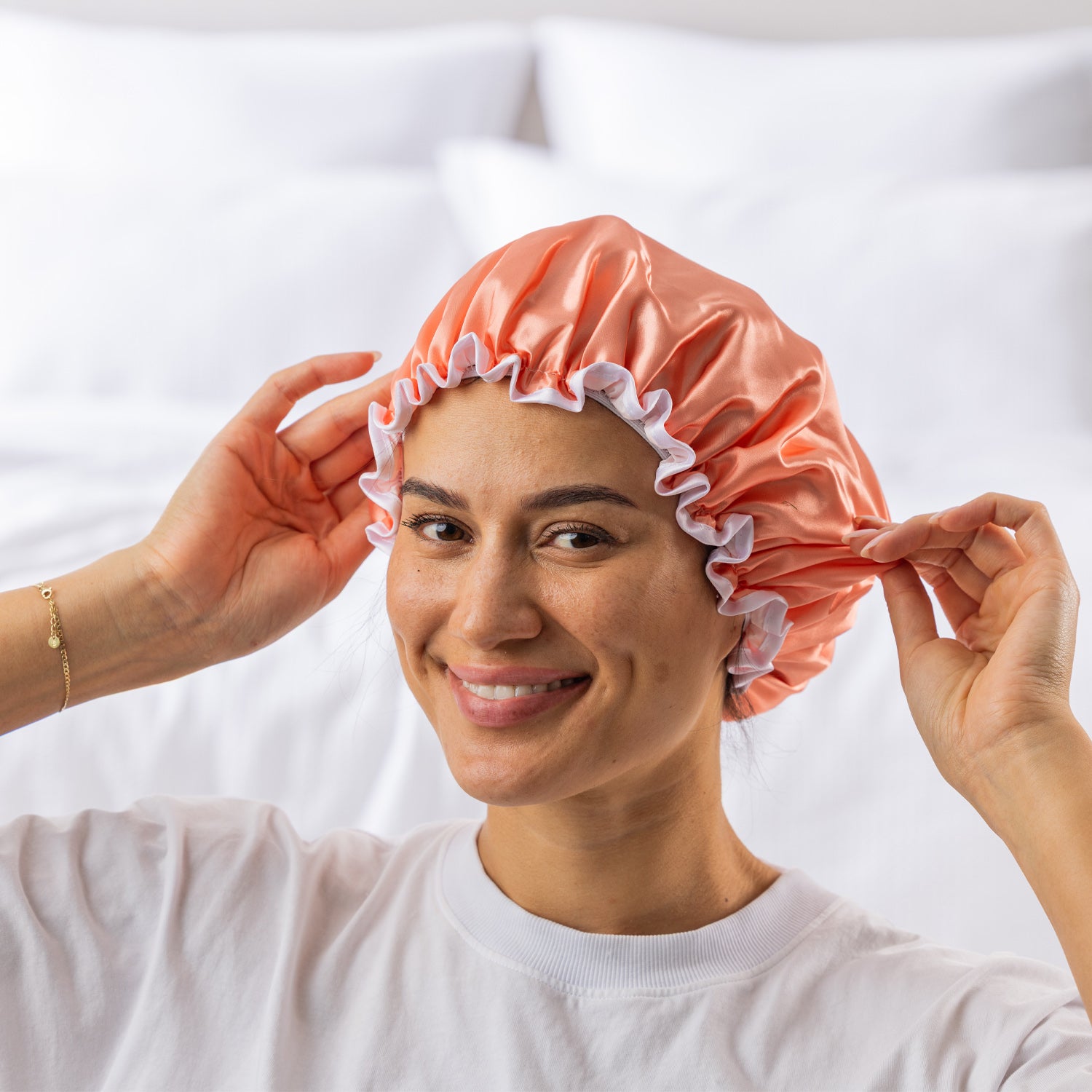 Grace & Gild Freya Pamper Set in peach, showing a model wearing the blue satin shower cap.