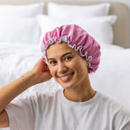 Grace & Gild Freya Pamper Set in rosewater, showing a model wearing the blue satin shower cap.