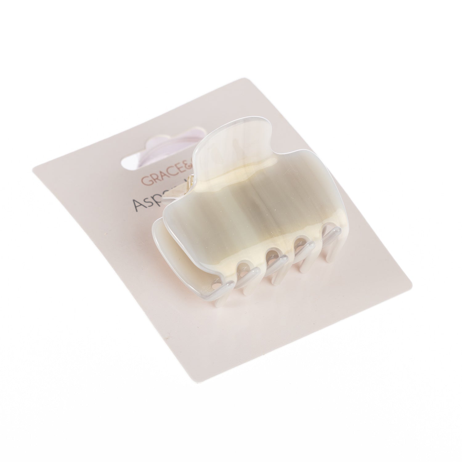 Grace & Gild Aspen hair claw clip in an ivory marbled finish displayed on retail packaging.
