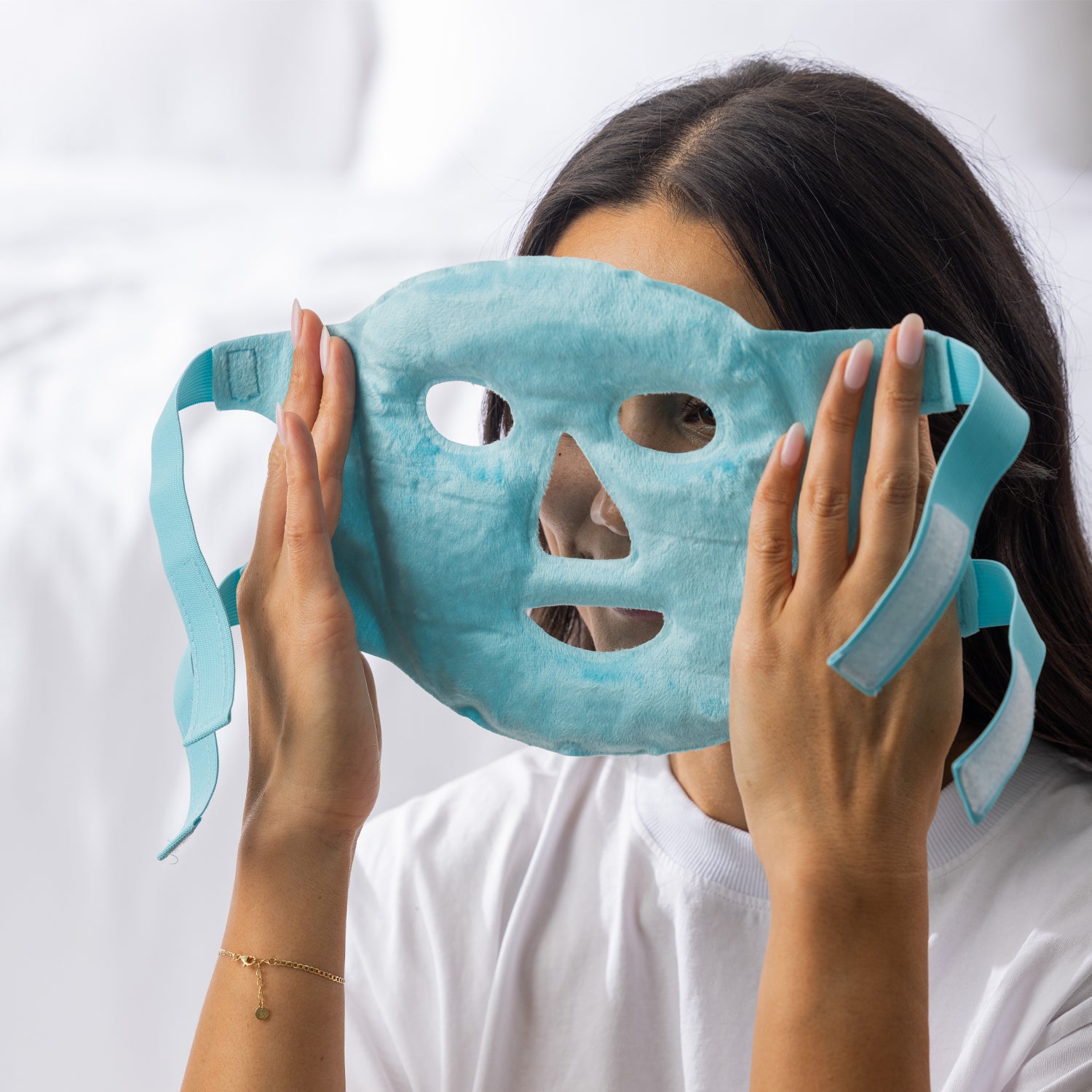 Grace & Gild Cooling Gel Bead Face Mask Sky Blue being held with the soft plush side facing out.