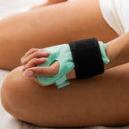 Grace & Gild Cooling Gel Bead Wrist Wrap Light Green wrapped around the hand and wrist with black adjustable strap.