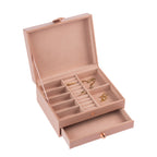 Open jewellery organiser featuring multiple divided compartments, ring rolls, soft pink lining and a pull-out drawer for storing rings, earrings, necklaces and other small accessories.