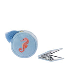 Sky blue seahorse jewellery organiser displayed alongside a matching compact mirror, featuring an embroidered seahorse design and blue tassel.