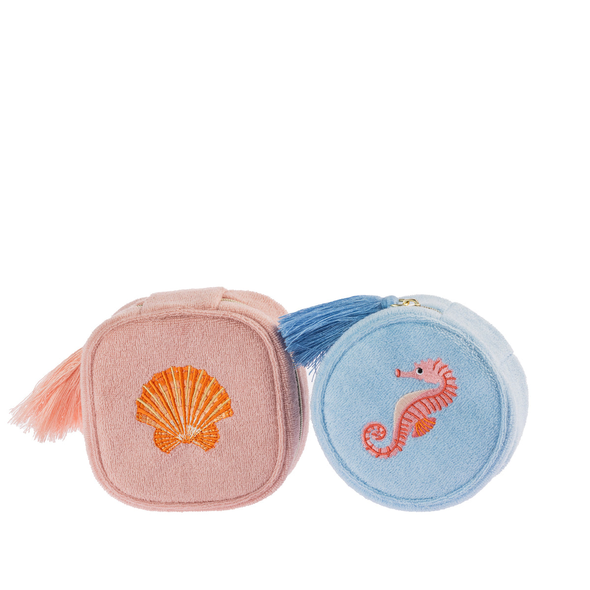 Two jewellery organisers in blush pink and sky blue, featuring embroidered seashell and seahorse designs, textured finishes and matching tassel zip pulls.