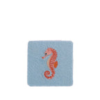 Sky Blue compact mirror featuring a textured fabric finish with a pink and coral embroidered seahorse design.