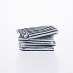 A neatly folded stack of white cotton dishcloths with fine blue stripes is presented against a clean white background, highlighting their soft texture and classic design.