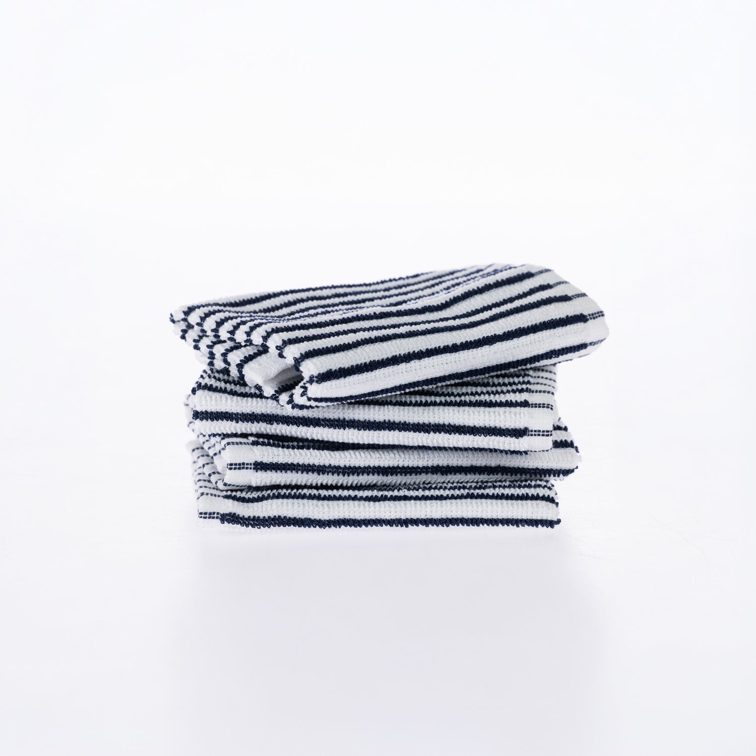 A neatly folded stack of white cotton dishcloths with fine blue stripes is presented against a clean white background, highlighting their soft texture and classic design.