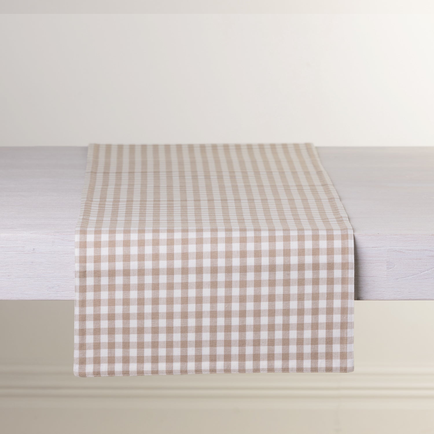 Gather Vichy Checks fused table runner in Brown/Cream displayed across a white dining table.