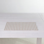 Gather Vichy Checks fused placemat in Brown/Cream laid flat on a white dining table.