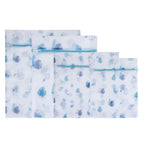 A set of reusable mesh laundry bags in assorted sizes features a blue tropical leaf print and secure zip closures to help protect delicate clothing during washing.