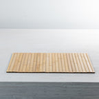 Gather Bamboo Placemat in Natural, showcasing its rectangular shape, smooth bamboo slats and warm natural tones on a white dining table.