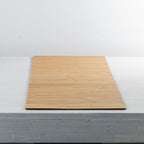 Gather Bamboo Runner in Natural, featuring a rectangular design with closely spaced bamboo slats and a smooth natural finish, displayed flat on a white table.