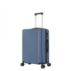 bb&b Travel Menton Suitcase in denim blue, shown from a side angle with textured hard-shell exterior, spinner wheels, and an extended handle.