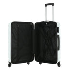 Angled view of the Medium mint hard-shell suitcase showing the ribbed shell, zip closure, side carry handle and spinner wheels.